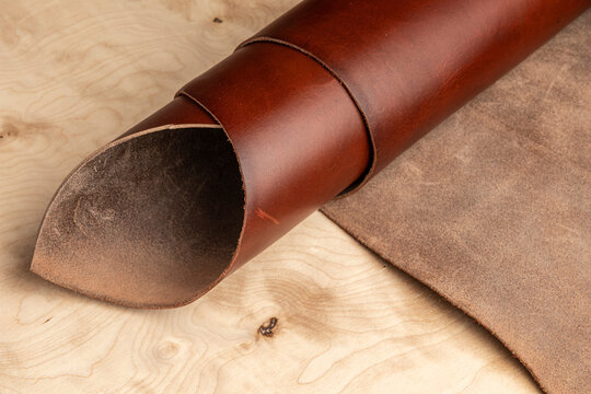 leather in a roll on a tree for manual processing by a leather craftsman