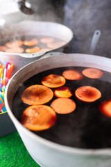 Christmas mulled wine at the fair brewed in a cauldron with cinnamon and citrus. Cooking a traditional Christmas and New Year's drink