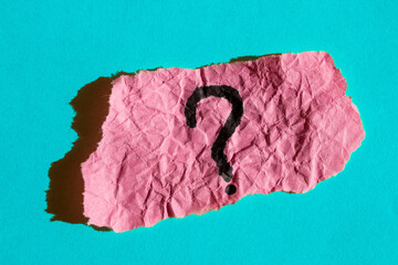 Question mark drawn on a pink paper. Curiosity, uncertainty and confusion concepts. Conceptual image.