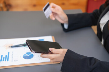 Young Asian woman shopping online using a credit card. for online payment within the house credit card payment concept