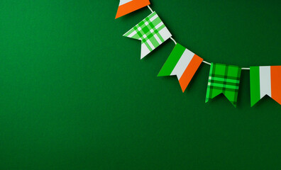 Saint Patrick day concept flat lay with garland flag, and on yellow background - obrazy, fototapety, plakaty