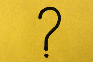 Question mark drawn on a yellow paper. Curiosity, uncertainty and confusion concepts. Conceptual...