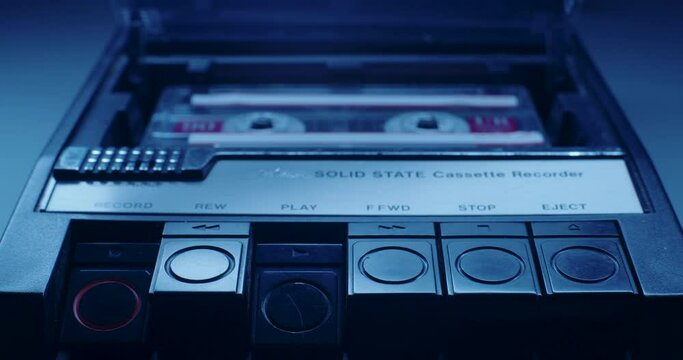 Cassette Tape Ejected From Player In Blue Light