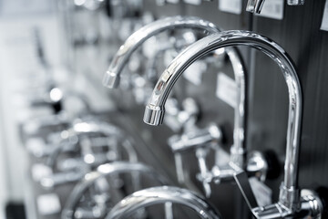Rows of metal water taps at the showroom of a large store