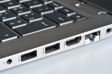Headphone jack, Usb ports, HDMI and rj45 lan port on the side of a modern laptop. Closeup
