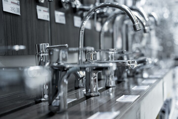 Rows of metal water taps at the showroom of a large store