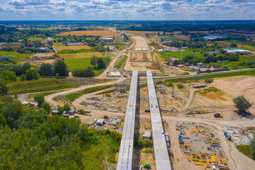 Aerial shot passing over a bridge construction project at sunset in Vistula near Warsaw.  Construction of the Most Polnocny bridge. Poland