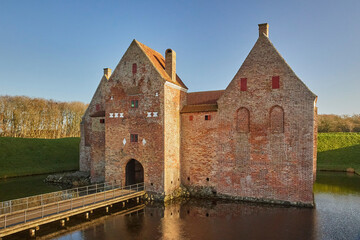 Majestic castle surrounded by a moat in Denmark at sunset