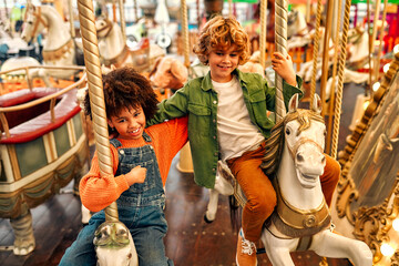 Fototapeta na wymiar Kids having fun on a carnival Carousel