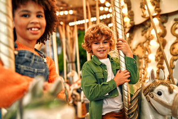 Kids having fun on a carnival Carousel
