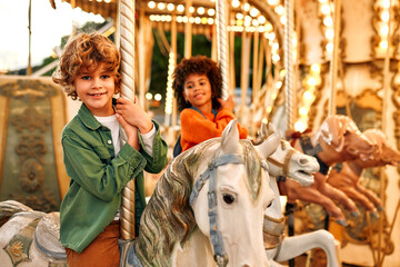 Kids having fun on a carnival Carousel