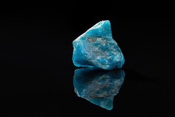 Raw Blue Apatite Uncut Gem Stone on Black Surface