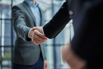 Two diverse professional business men executive leaders shaking hands at office meeting - obrazy, fototapety, plakaty