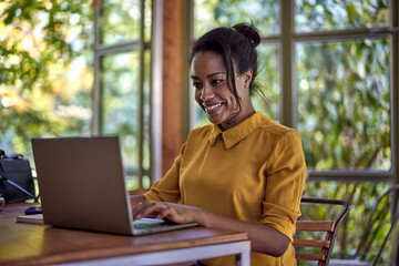 smiling young businesswoman using laptop