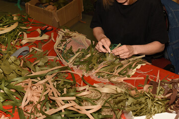 The concept of military protective equipment and camouflage cover with grass imitation. War in Ukraine. Volunteer work.