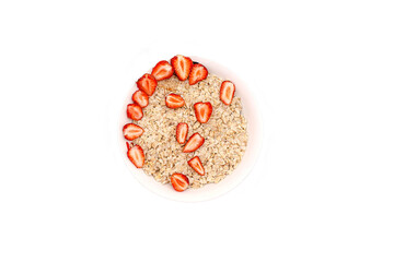 Oatmeal porridge with summer strawberries berries. Porridge oats in bowl. Healthy food breakfast,lifestyle,dieting, proper nutrition. Top view flat lay on gray table background, copy space - obrazy, fototapety, plakaty