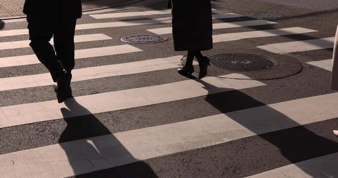 A slow motion of walking people leg on the city street 