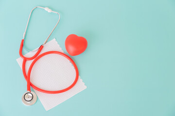 Red heart and paper with doctor physician's stethoscope, World heart health day, doctor day.
