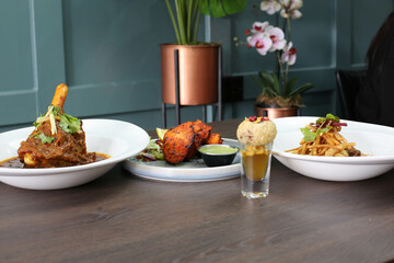 chicken tikka pieces, lamb shank, pan puri shot