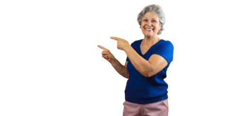 Women's Day - Smiling Mature Woman Pointing Isolated on Orange Background