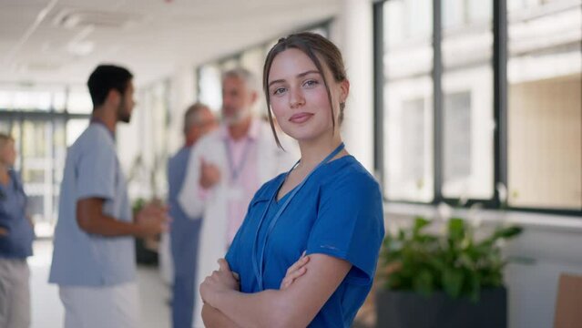 Young woman doctor at hospital corridor looking at camera.