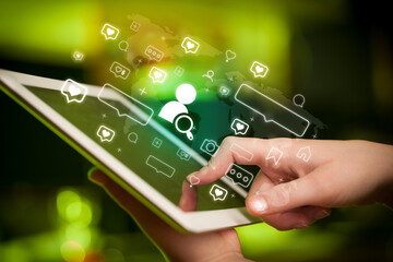 Close-up of a hand using tablet, social media concept