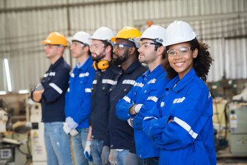 Group of diversity male and female engineer workers at work in the industry factory and wearing...