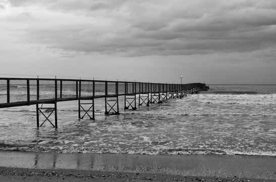 Landscape with long pier in the sea