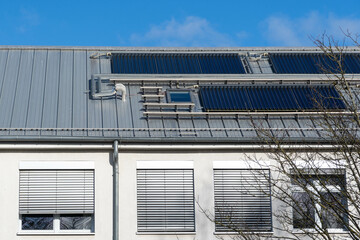 solar thermal system on a roof of a building, blue sky 