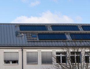Fototapeta premium solar thermal system on a roof of a building, blue sky 