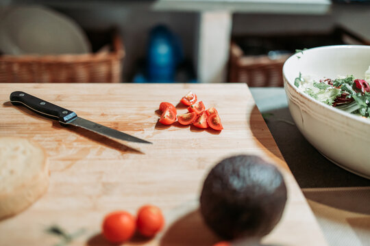 Slices of a cherry tomato on the kitchen board. Salad preparation. Healthy diet