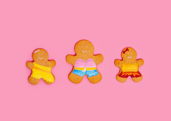 Gingerbread men on a pink background. Mother and baby girls. Happy women's day. Mother's Day - place for text.