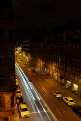 Сar lights at night on an old european street with long exposure