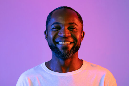 Closeup Portrait Of Handsome Black Man On Neon Background