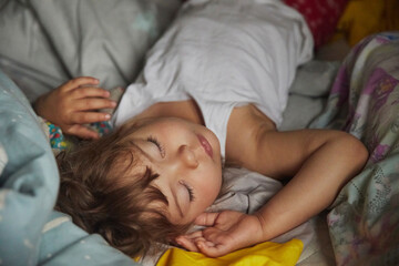 adorable baby sleeping in a dark room