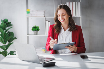 Happy Business woman entrepreneur holding chart working sit at office desk. Portrait of beautiful...