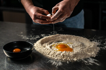 Chef preparing dough with egg. cooking process. Food recipe background. Close up