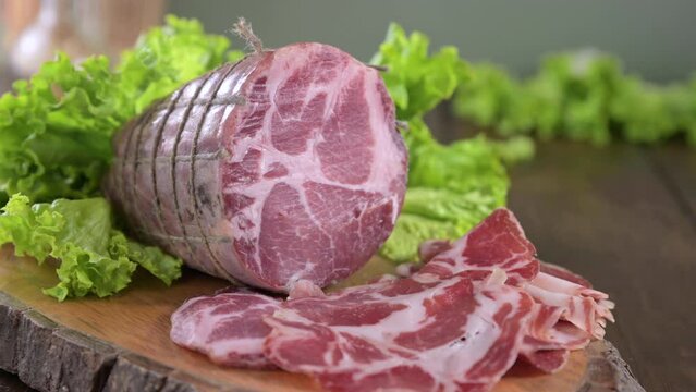 Capocollo or coppa is a traditional Italian and Corsican pork cut made from cured pork shoulder or neck. . Cut into very thin slices. Italian delicacy for aperitivo. Piacentina DOP. 4k footage
