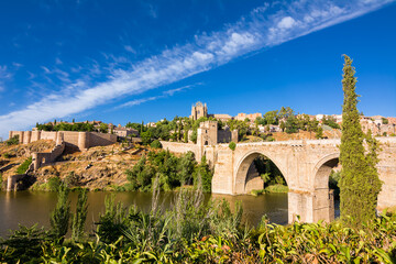 View of the San Martin Bridge crossing the Tagus to enter the old city of Toledo on the hill where you see the Old Cathedral