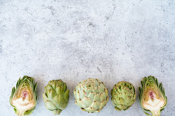 Top view Sliced artichoke on table. Healthy food vegetables on grey background with copy space