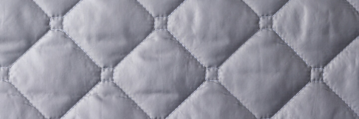 Quare seam on silver gray fabric closeup