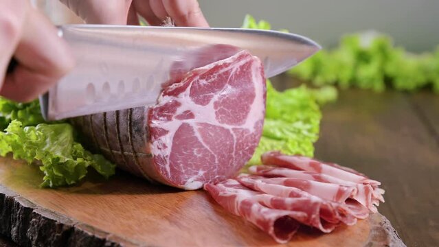 Capocollo or coppa is a traditional Italian and Corsican pork cut made from cured pork shoulder or neck. . Cut into very thin slices. Italian delicacy for aperitivo. Piacentina DOP. 4k footage