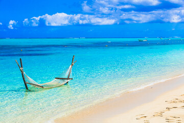 Naklejka na ściany i meble Tropical relaxing holidays - hammock in turquoise water in Maldive islands. exotic tropics vacation