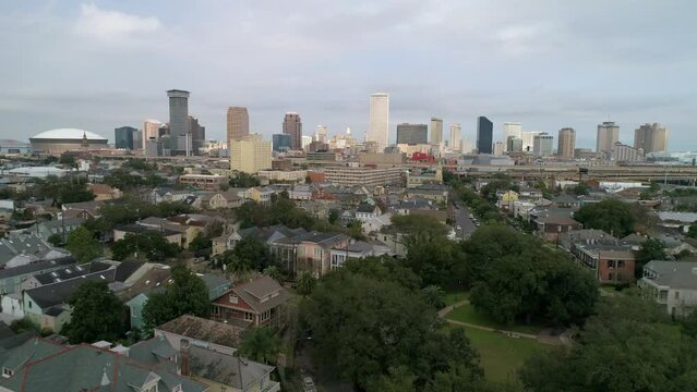 Aerial Shot Of Caesars Superdome Amidst Buildings, Drone Flying Forward Over City - New Orleans, Louisiana