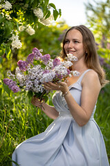 Portrait Girl with Flowers Lilac in the Garden in Spring