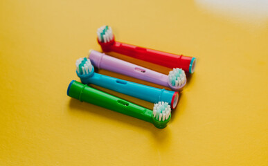 Attachments for an electric toothbrush on a colored background
