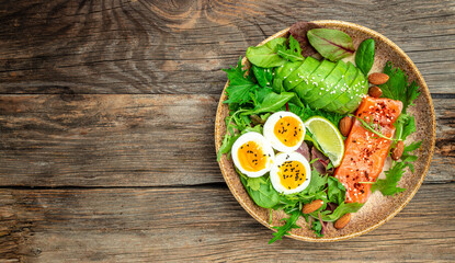 salmon salad with greens, eggs and avocado. Delicious breakfast or snack, Healthy keto lunch or dinner. top view copy space