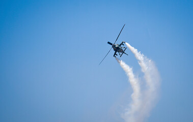 Fototapeta na wymiar helicopter chopper airshow airplane flight formation with contrail
