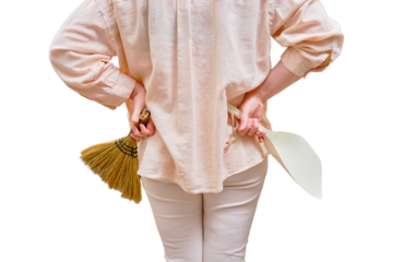 A woman with a broom and a dustpan is preparing for cleaning in the home living room, isolated on a white background