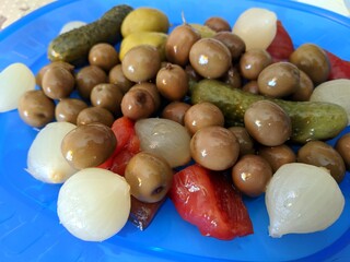 Green olives in bowl on table close-up